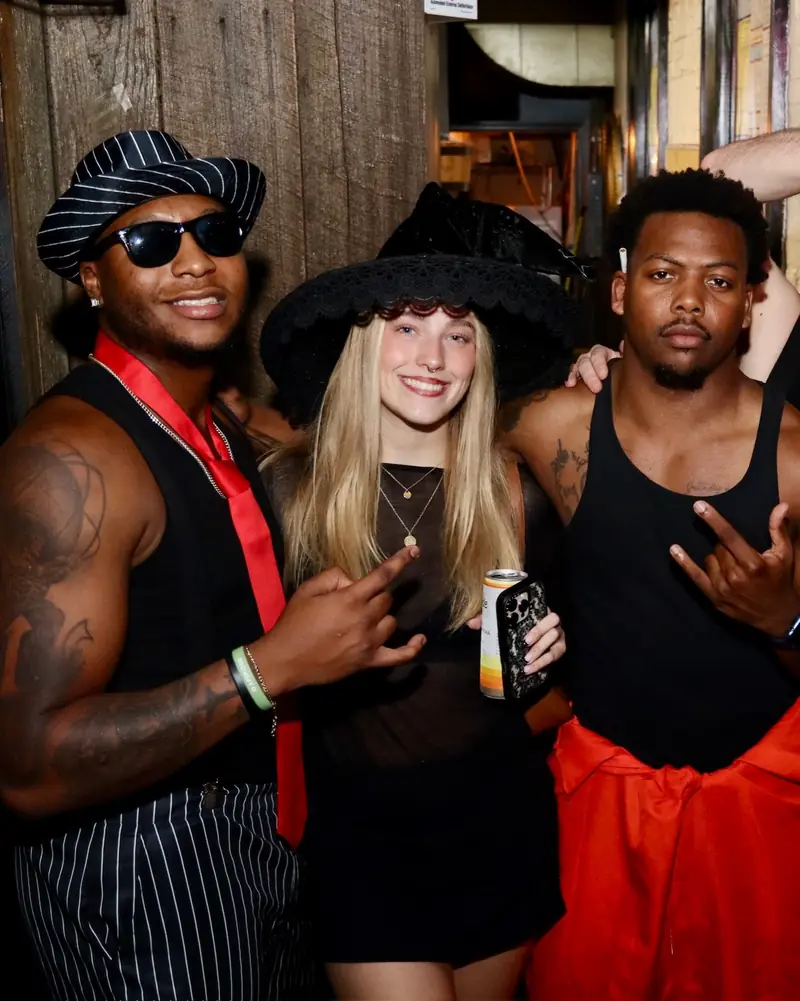 Friends in costume at a Wayward party