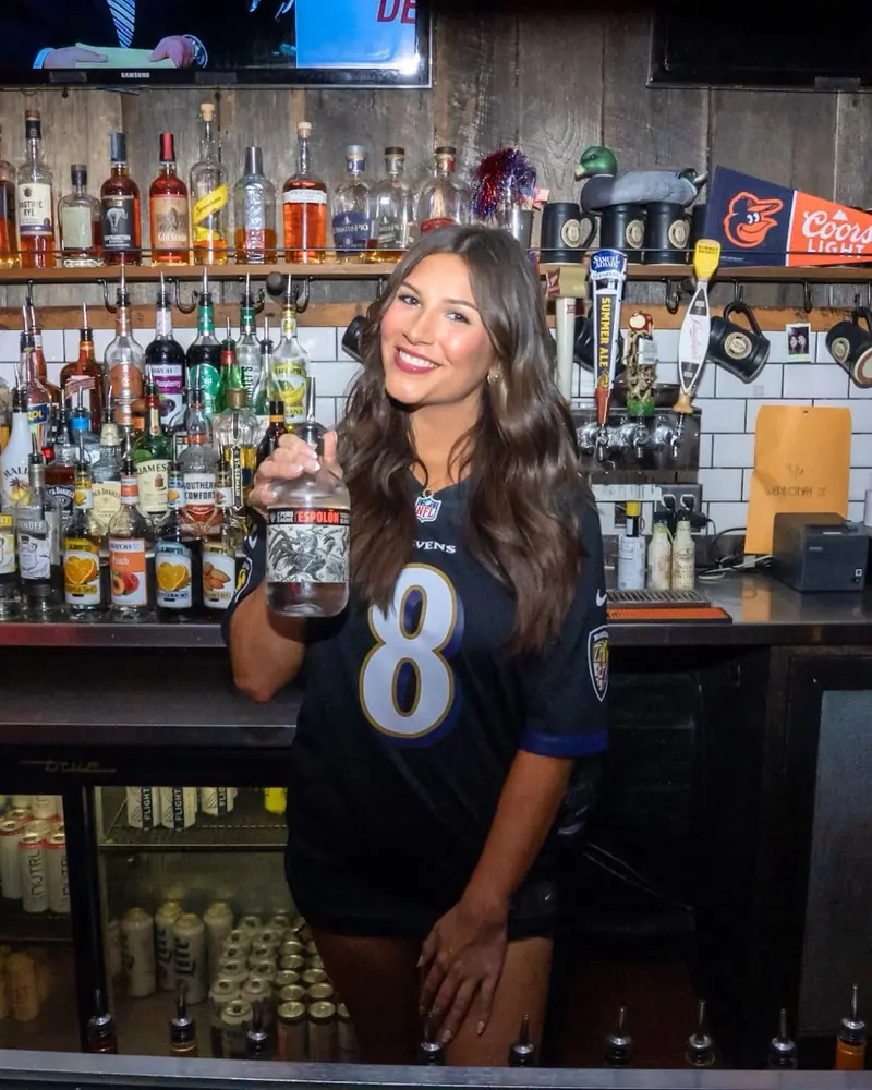 A Ravens fan behind the bar at Wayward